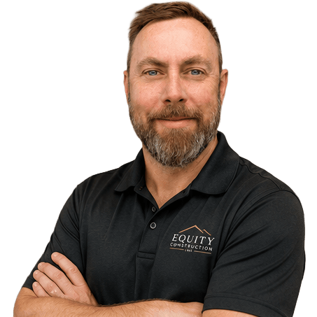 Professional headshot of Jay Alderson from Equity Construction Inc. smiling with arms crossed, wearing a black branded polo shirt against a transparent background.